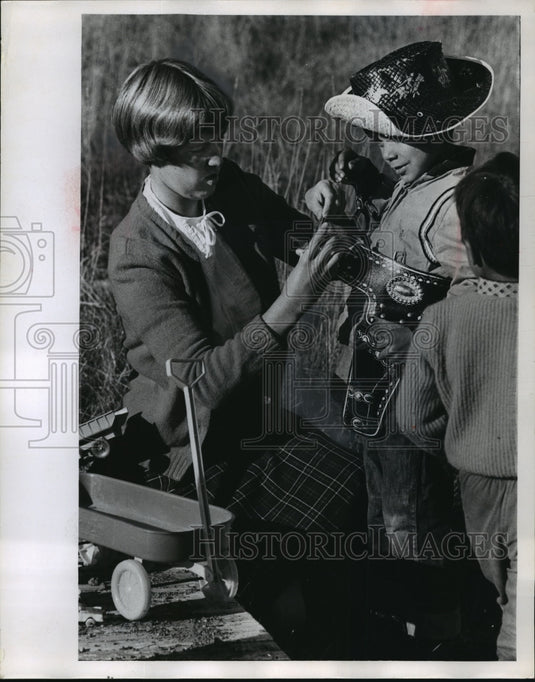 1967 Miss Bradley adjusted Thomas Quagon's gunbelt  - Historic Images