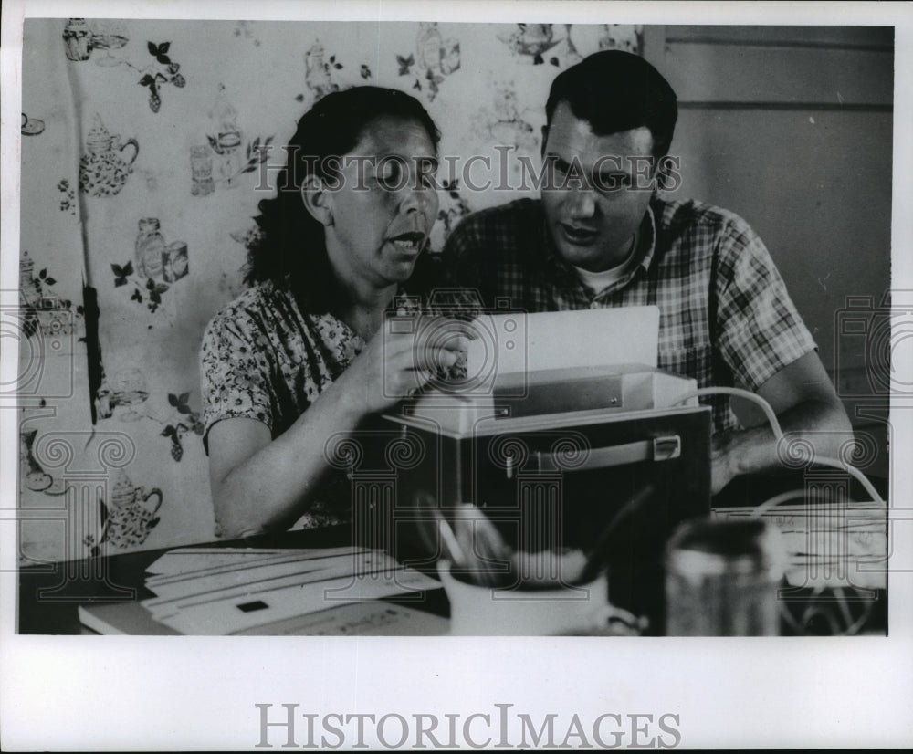 Clifford Schweitzer teaches Mrs. Ignacis Gomez to pronounce English - Historic Images
