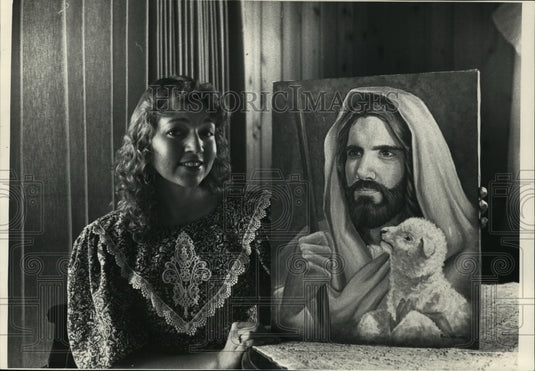 1988 Sandi Beecroft sits with a painting by Rice Lake artist-Historic Images