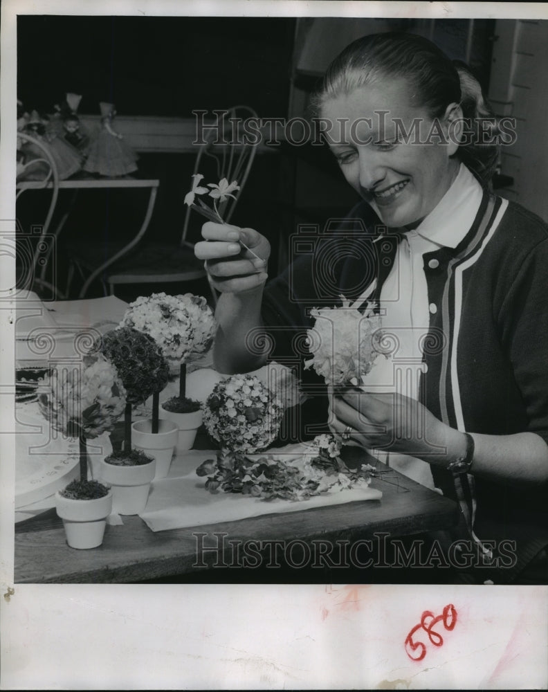 1956 Press Photo Mrs. Robert Brumder adds blossom to floral globe decorations - Historic Images