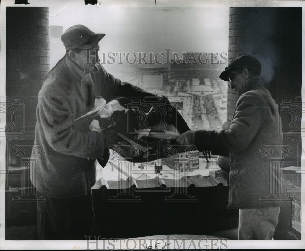 1962 August Heinitz preparing to put flag up City Hall Tower - Historic Images