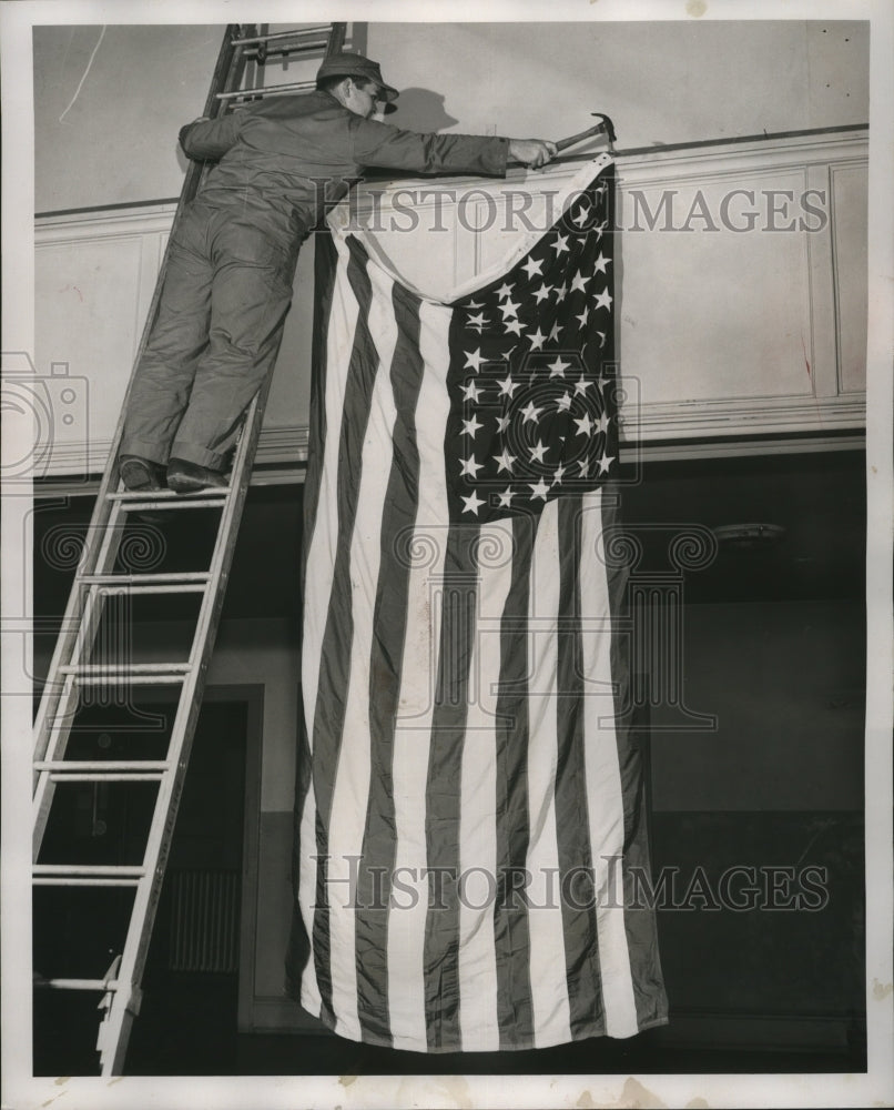 1954 Press Photo Marine shown hanging a flag in the proper manner - mja18308-Historic Images