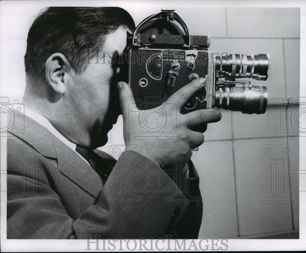 Press Photo A man holding a small camera device - mja19998-Historic Images