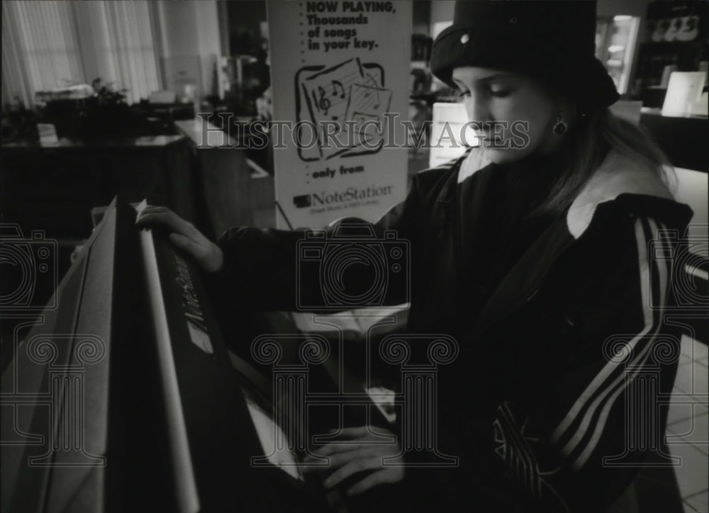 1994 Press Photo Marth Schmitt tries the NoteStation Sheet Music Library. - Historic Images