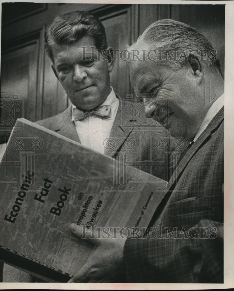 1965 Press Photo Chester O. Wanvig, Jr, views economic fact book - mja25129 - Historic Images