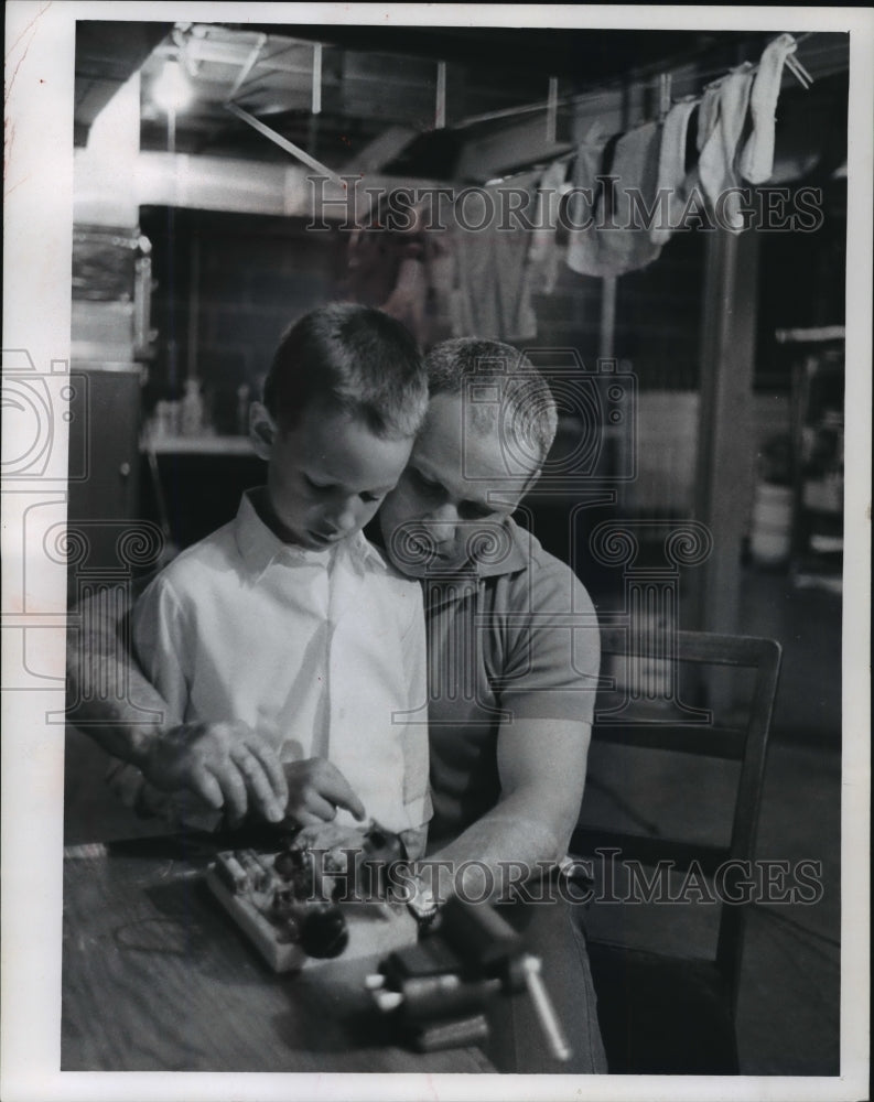 1957 Press Photo Roland Konjeczki and son, James tinker in the basement-Historic Images