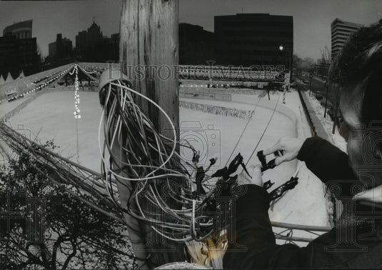 1994 Press Photo Brian Tibbets inspect outdoor wiring for the lights in the rink-Historic Images