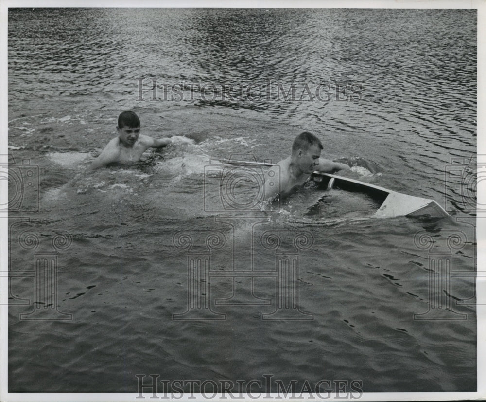 1960 Press Photo Larry Garcia, James Anderson Paddle Water-Filled Canoe To Shore-Historic Images