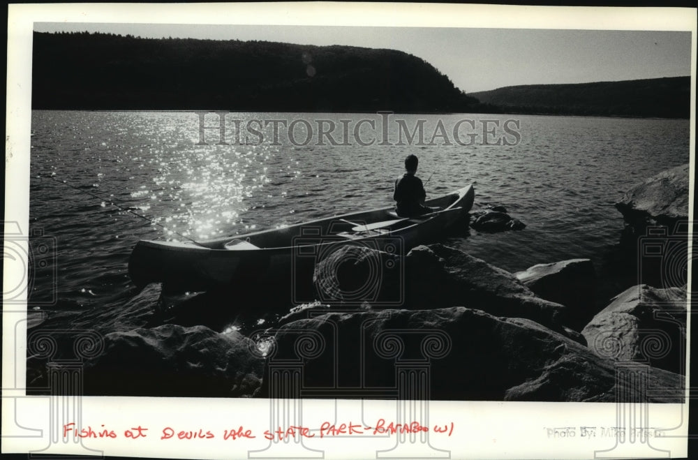 1991 Press Photo Fisherman drops a line in Devils Lake State Park near Baraboo-Historic Images