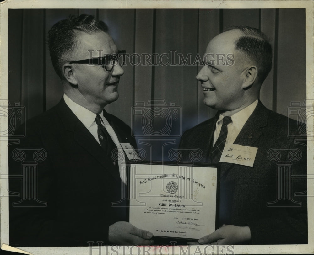 1966 Press Photo Art Peterson presents an award to Kurt W. Bauer. - mja44987-Historic Images