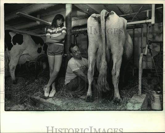 1987 Press Photo Renee Larsen Watches As Cow Is Milked - Historic Images