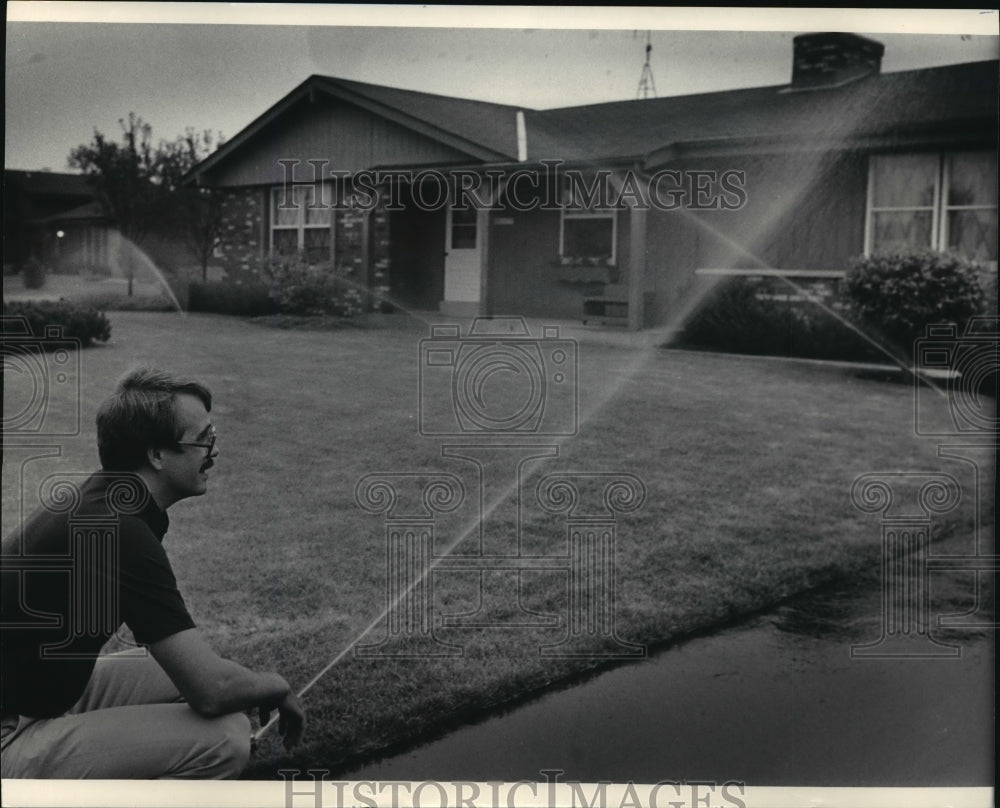 1985 Press Photo Thomas Emmerich Checks Sprinklers At His Brother Robert&#39;s Home - Historic Images
