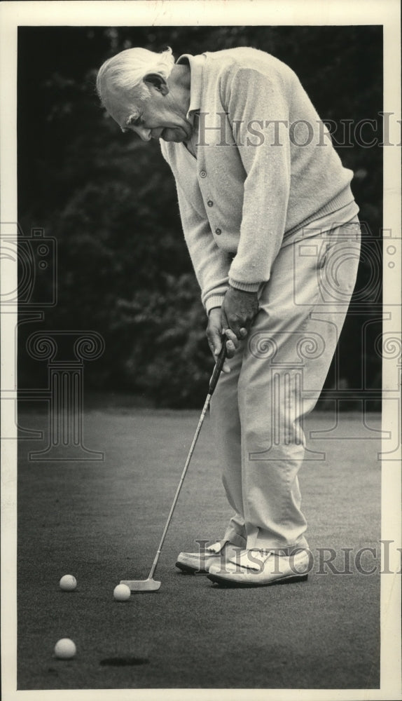 1985 Press Photo John Zussman lining up a putt on a recent golf outing - Historic Images
