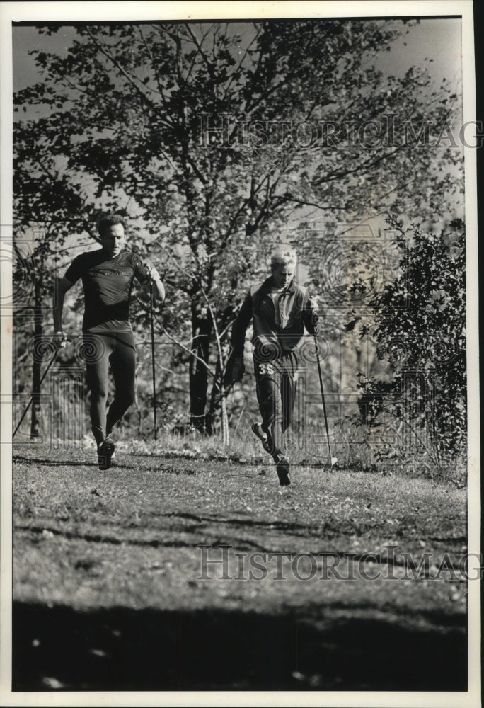 1990 Cross Country Ski Coach and Racer Engage in Dry Land Training - Historic Images