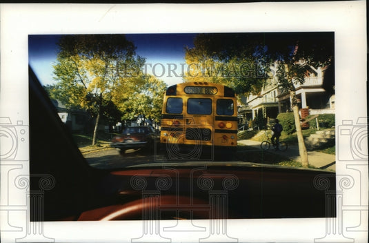 1992 Press Photo Car Legally Passes Stopped School Bus in Milwaukee, Wisconsin-Historic Images