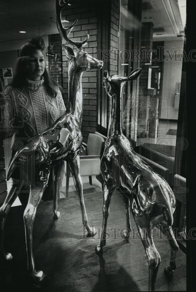 1969 Press Photo Tracy Schuster with brass deer in lobby Brown Deer Village Hall-Historic Images
