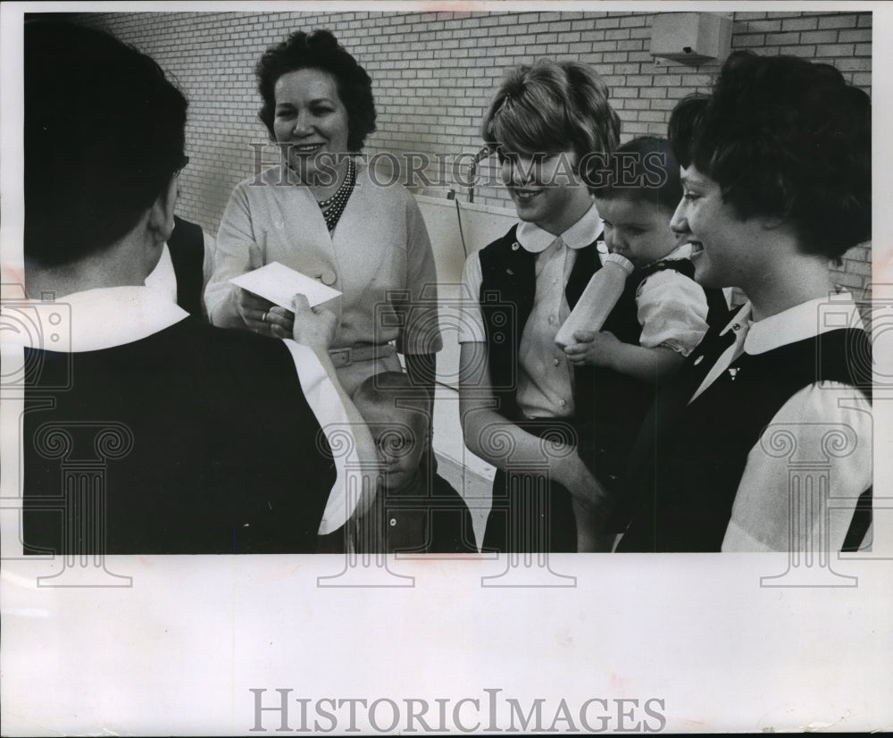 1963 Susan Beste Hands Check to Mrs. George Brost  - Historic Images