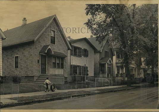 1967 A child plays on sidewalks of Blacksing, Milwaukee's inner core - Historic Images
