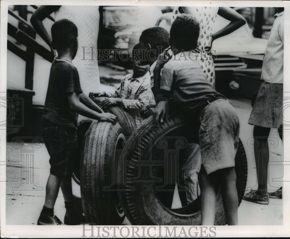 1966 Press Photo Blacks-Milwaukee, youngsters used tires to roll on sidewalks-Historic Images
