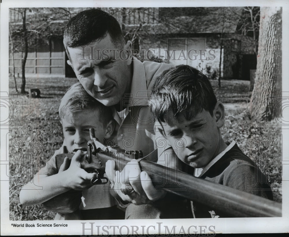 1968 Astronaut William Anders showing sons antique gun  - Historic Images