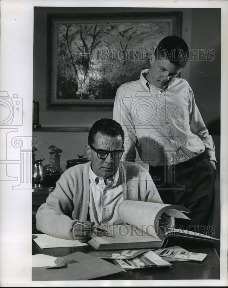 1964 Press Photo Rep. John Byrnes explains endless homework to son, John - Historic Images