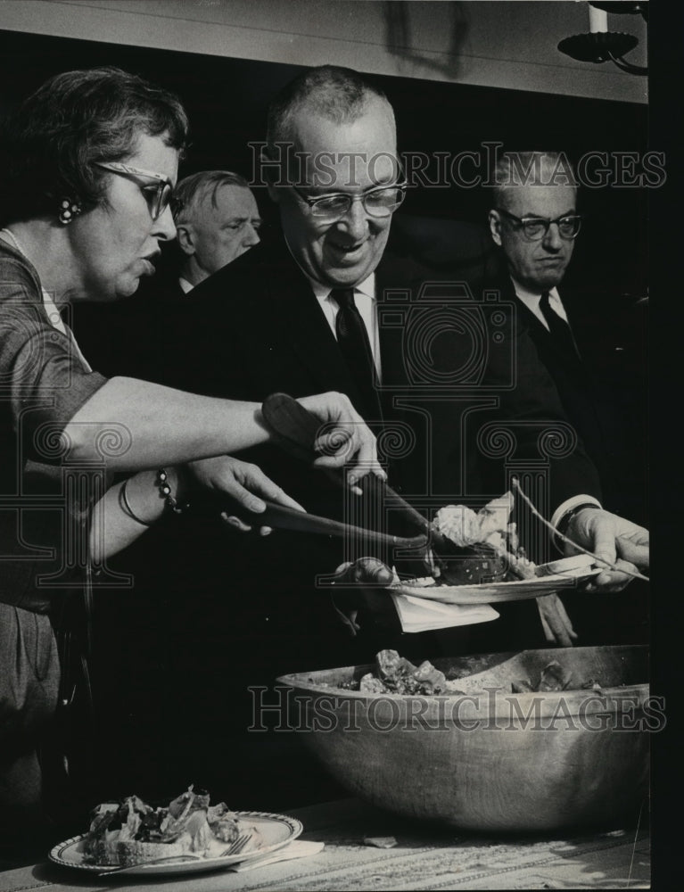 1964 Press Photo Host Harold W. Bostrom Helped To Salad By Mrs. Joseph Baldwin-Historic Images