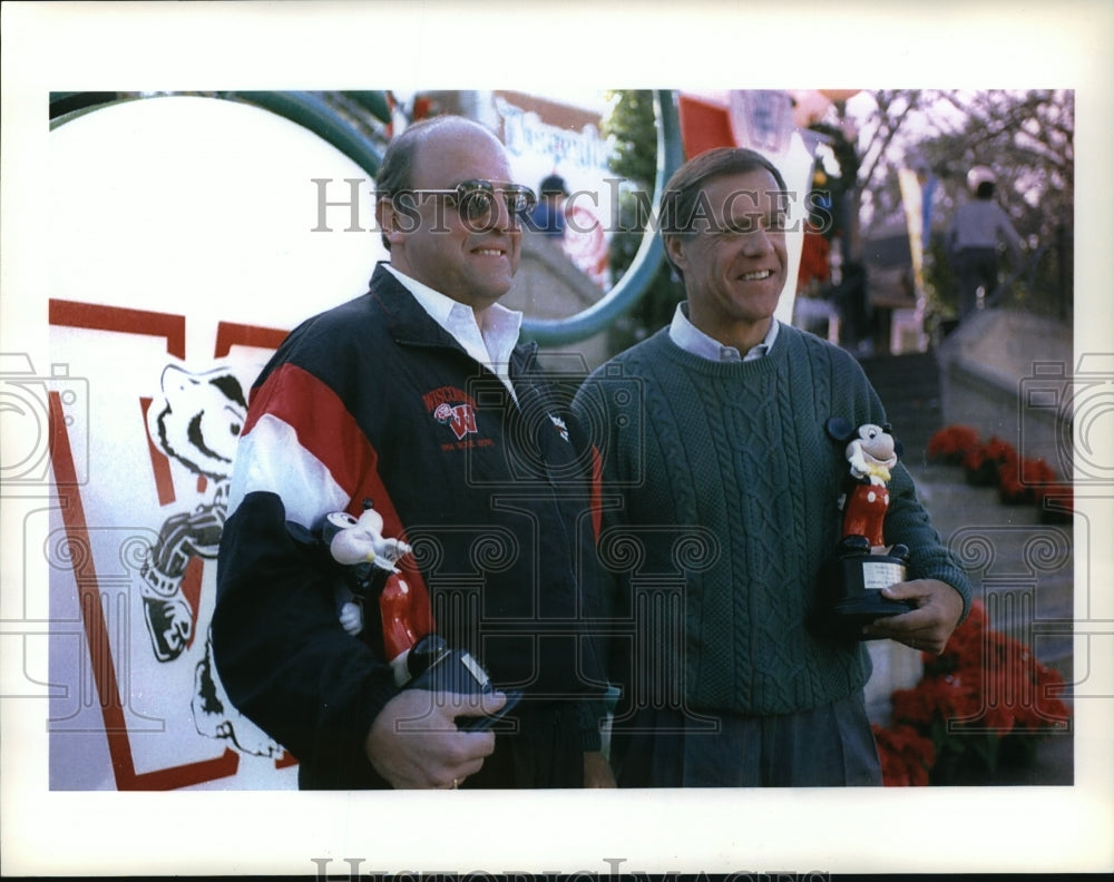 Press Photo Wisconsin Badgers football team members hold Mickey Mouse trophies-Historic Images