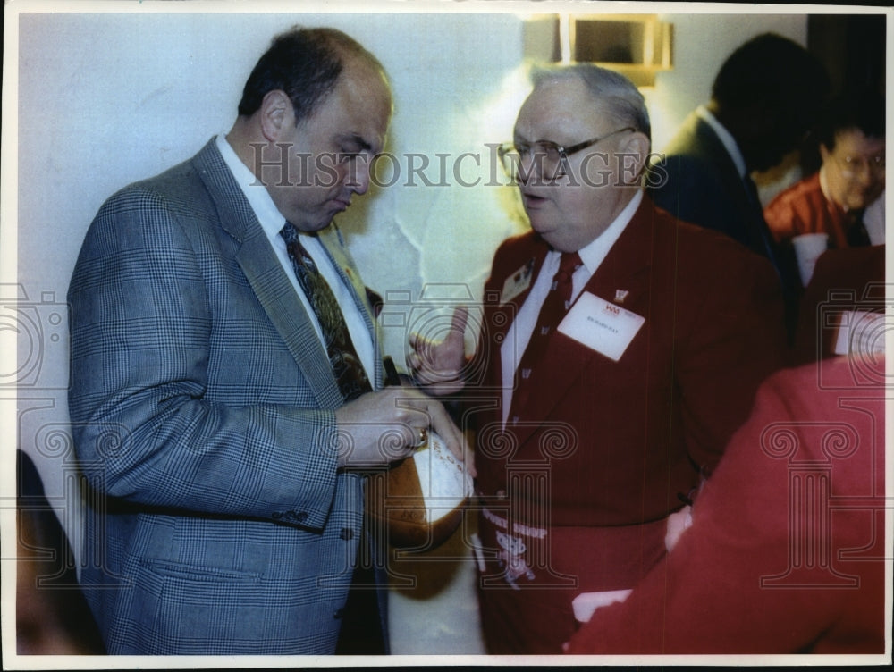 1993 Press Photo Barry Alvarez signs University of Wisconsin football for a fan - Historic Images