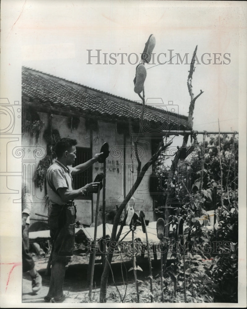 1964 Press Photo A peasants washes $1.60 shoes he owns, Communist country-Historic Images