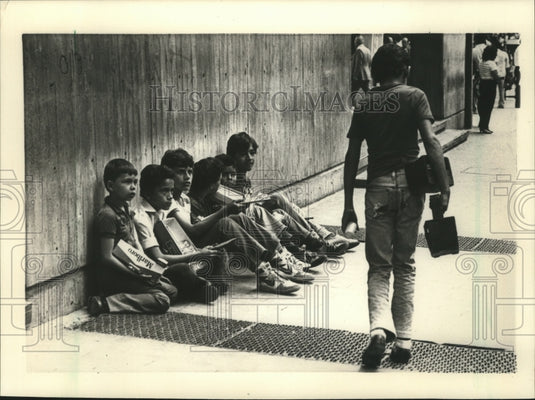 1985 School-age children sell candy & cigarettes to help family.-Historic Images