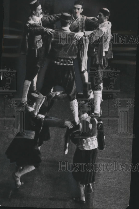 1956 Press Photo Men Standing Atop Each Other's Shoulders in Dance Performance-Historic Images