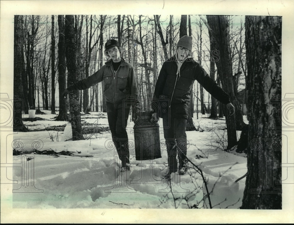 1985 Press Photo Robert Janowski and Allan Hopperdietzel carry sap to trailer - Historic Images