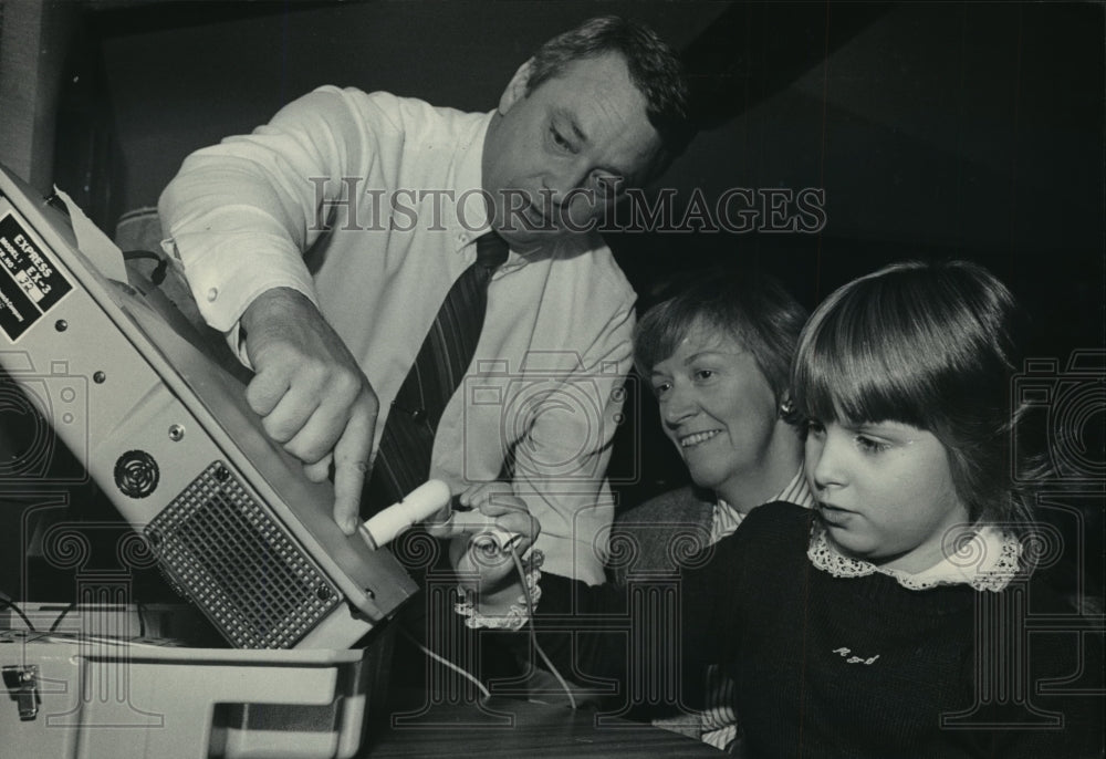 1983 Press Photo Tom Fell shows wife and daughter an audible microcomputer-Historic Images