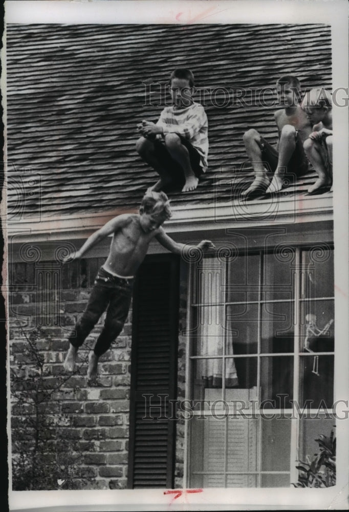 1965 Thomas Conrad son of Charles Conrad and friends playing on roof - Historic Images