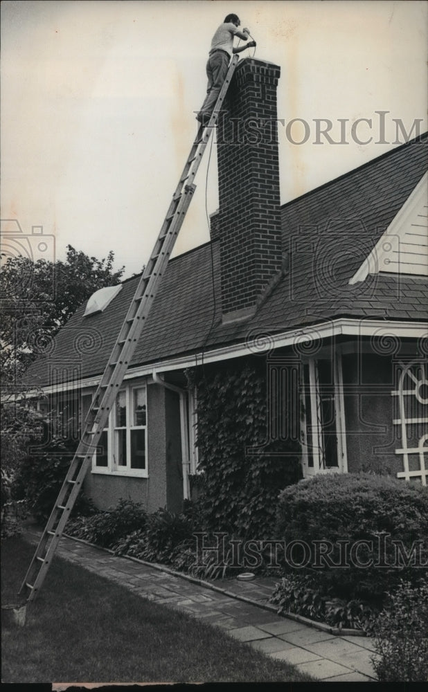 1977 Press Photo Chimney sweep Vincent Agnello climbs a 25 foot ladder to clean-Historic Images