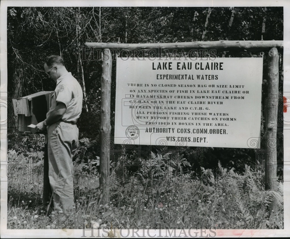 1955 Press Photo Conservation Worker Standing Next to No Fishing Limit Sign - Historic Images