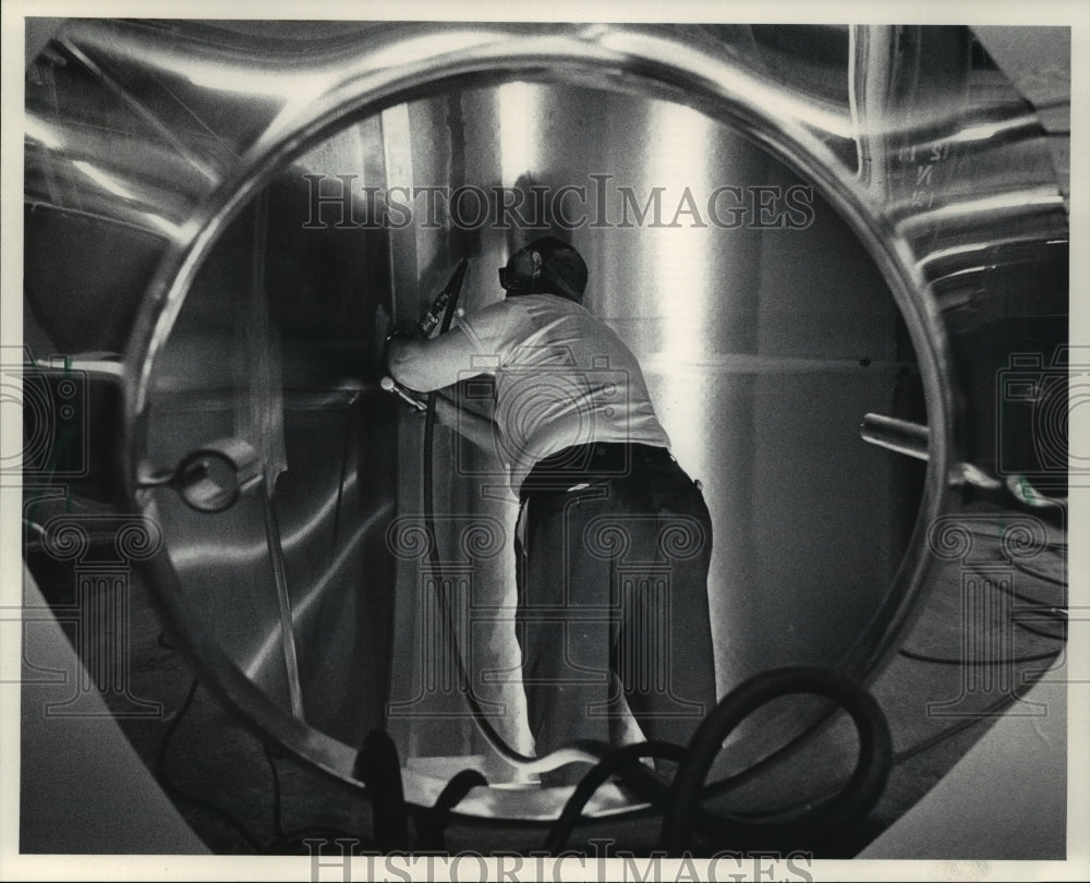 1984 Vic Smith, of Dairy Equipment Co.  polishes the inside of  tank-Historic Images