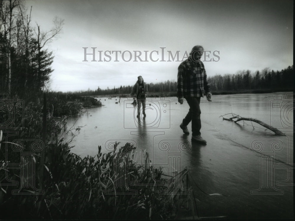 1993 Press Photo A father and daughter test the ice along Little Cisco Lake.-Historic Images