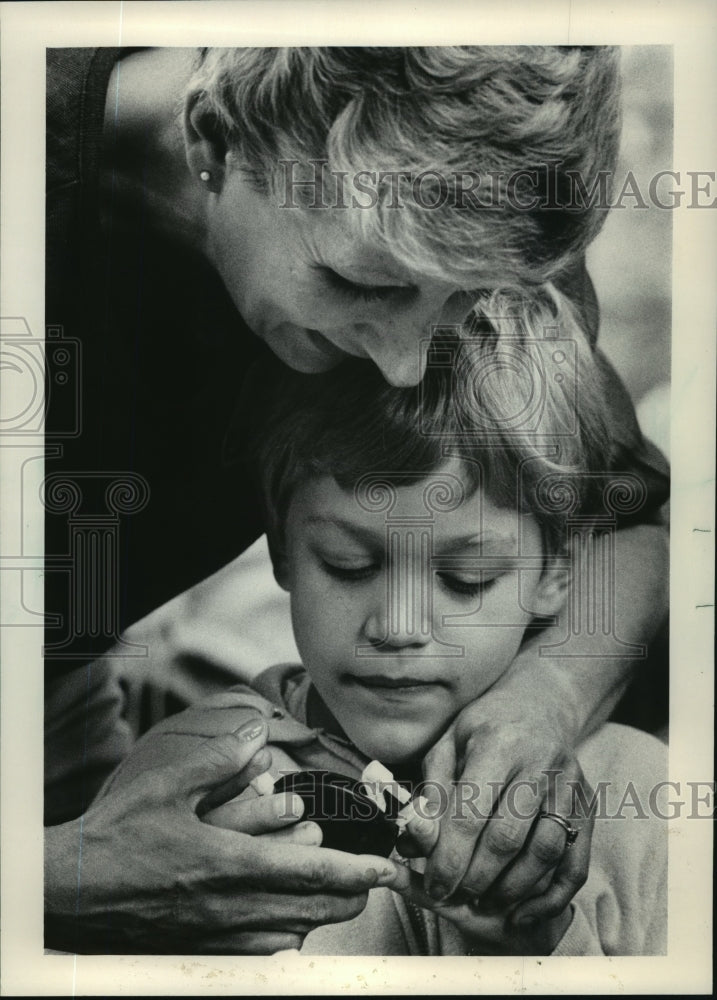 1983 Michael Bukosky gets help with a blood test from Susan Ziegert-Historic Images