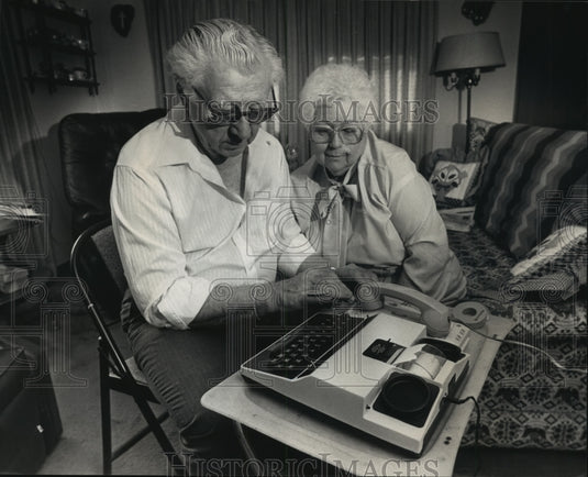 1989 Vincent and Margaret Abaravich use a communications device-Historic Images
