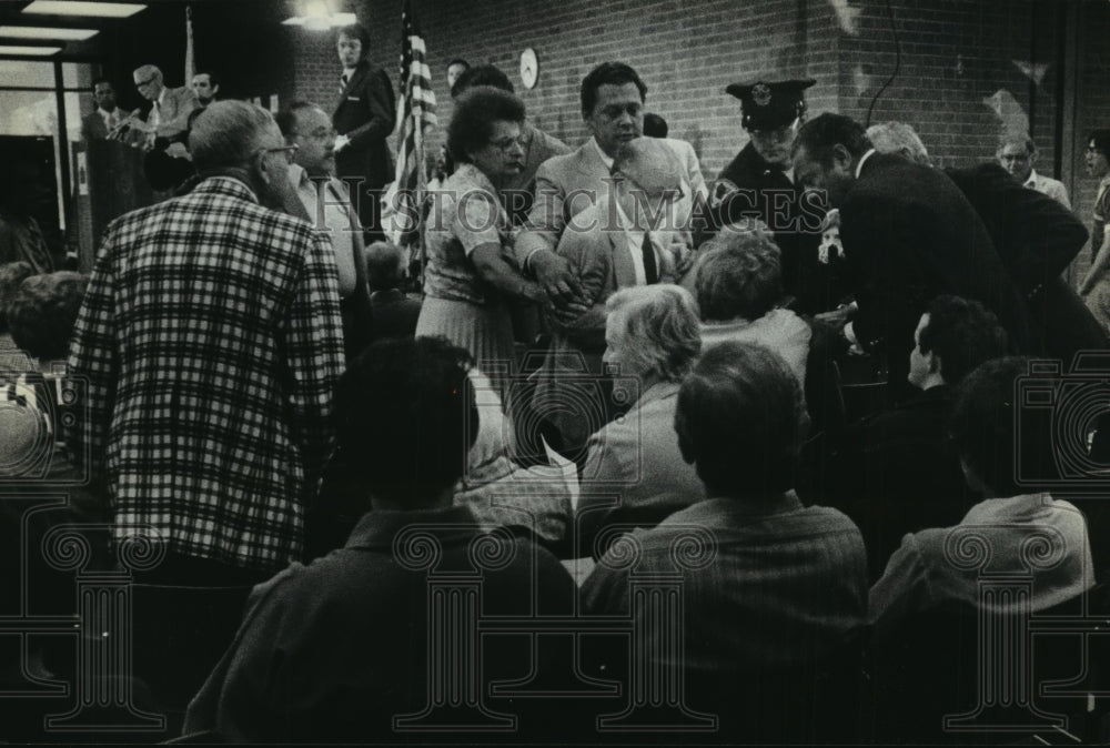 1979 Police and others gather around man who tried to stop a protest - Historic Images