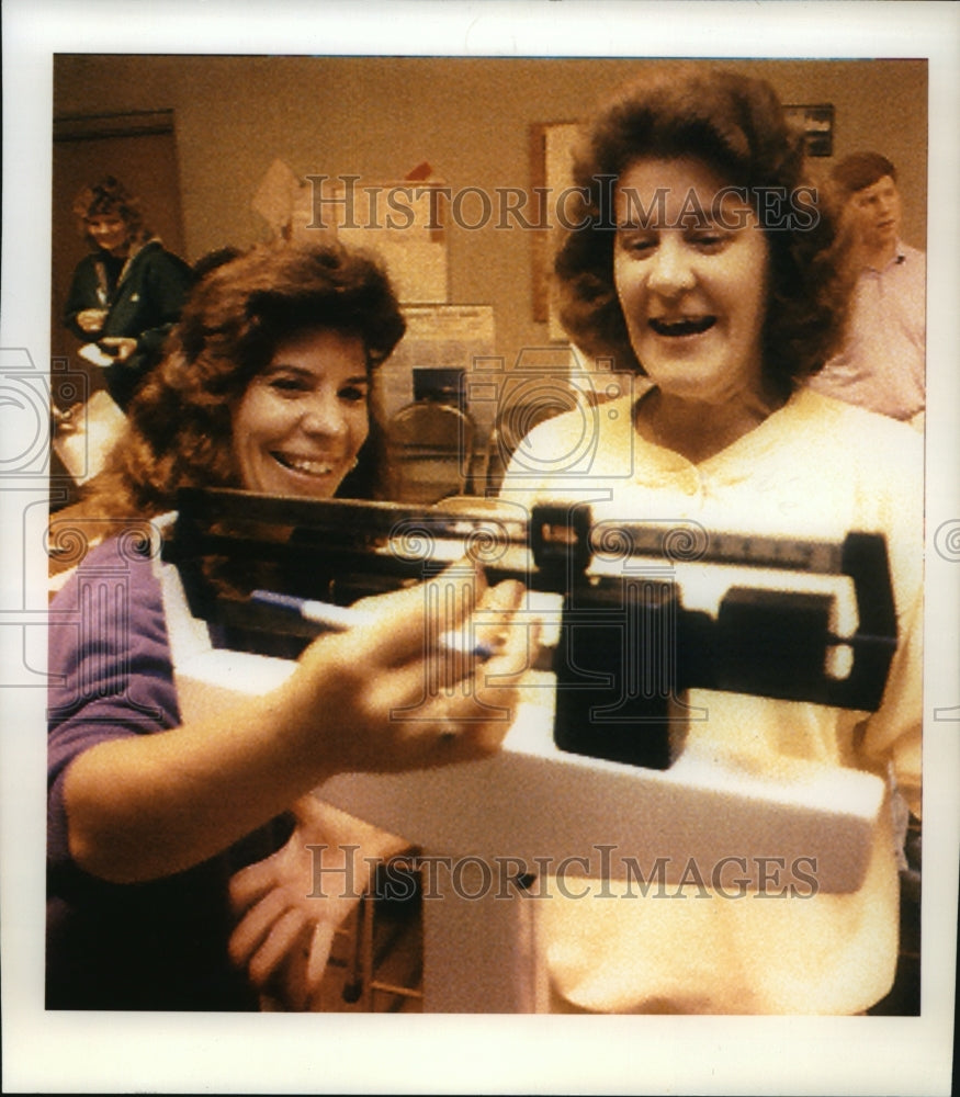 1992 Katie Nosgovits Being Weighted by Robin Sager; Pound, Wisconsin - Historic Images