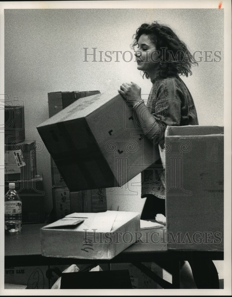 1992 Store manager Betsy Nelson, of Milwaukee, unloads boxes-Historic Images