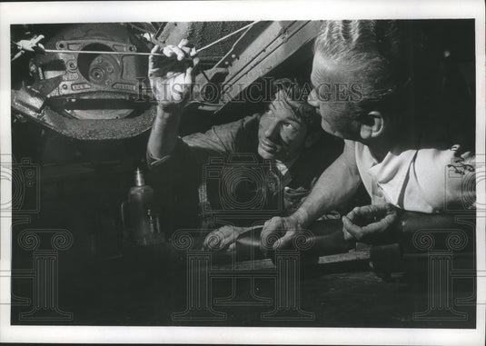 1969 Press Photo Bruce Shiefelbein and Frank Svajdlenka Inspect Brake Cable - Historic Images