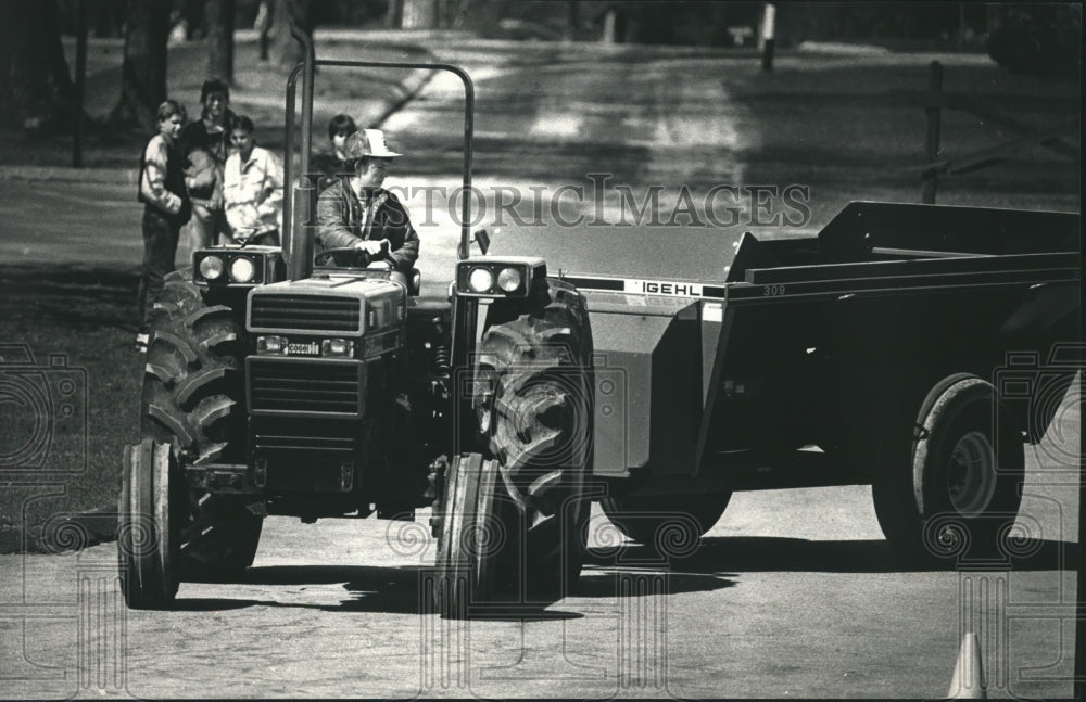 1988 Press Photo Ronald Frase, teenager, drives farm equipment - mjb02930 - Historic Images