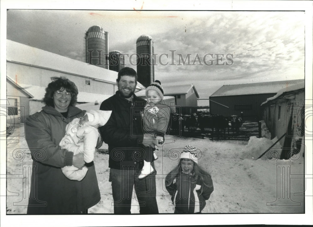 1991 Sharon and Jim Ziemer with children, at their Dairy Farm. - Historic Images