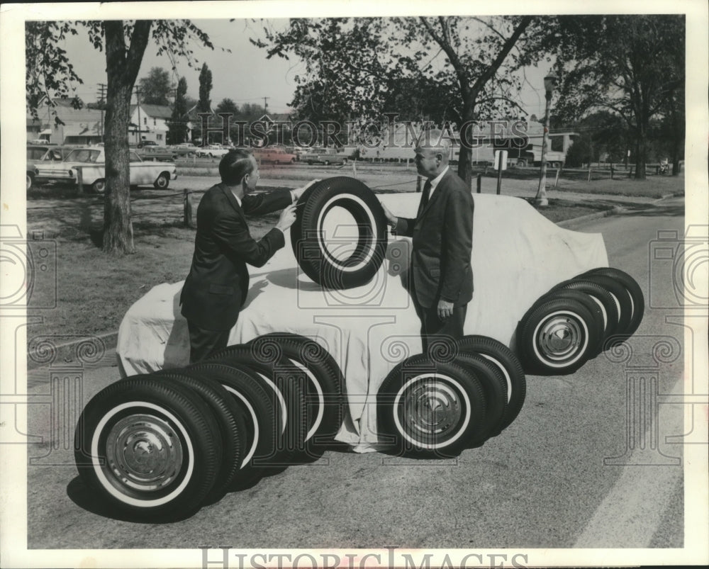 1963 Press Photo Two Firestone Officials Looking at Different Size Tires-Historic Images