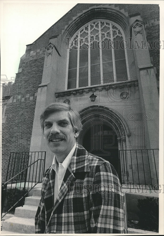 1984 Reverend Paul Flucke stands outside Plymouth Church, Milwaukee - Historic Images