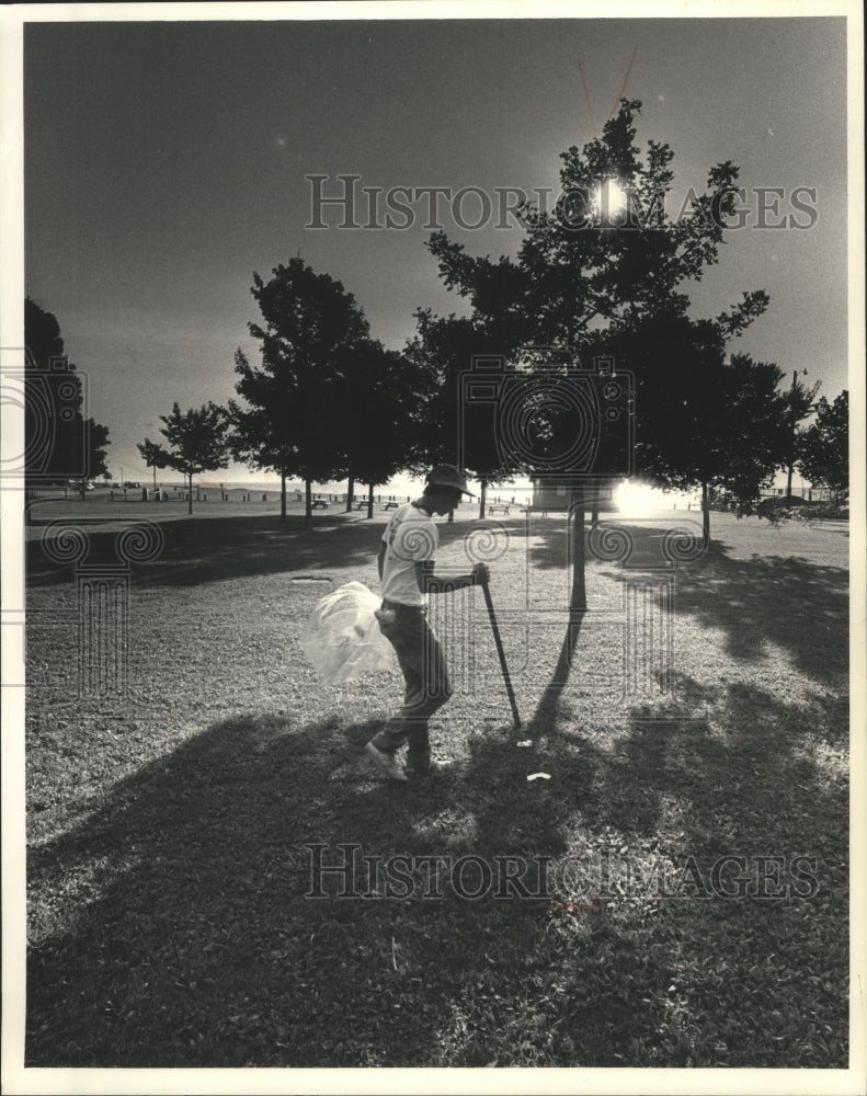 1986 Press Photo Irk Mario Jennaro Picking Up Others&#39; Trash On the Lakefront - Historic Images