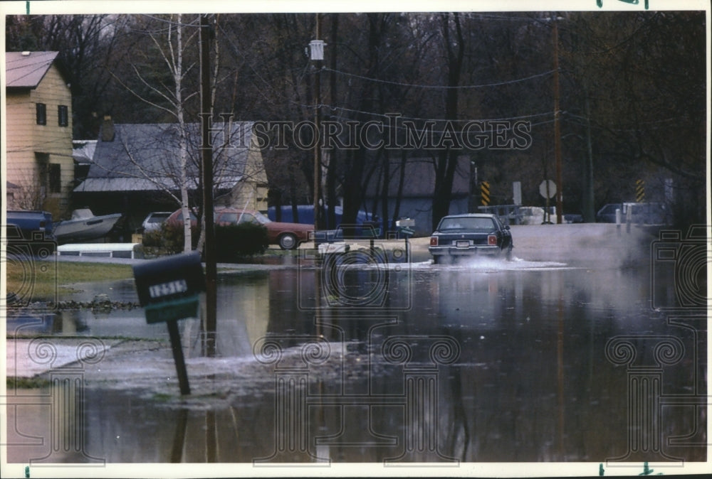 1993 A vehicle carefully leaves a driveway after floods in Wisconsin - Historic Images